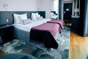 Säng eller sängar i ett rum på Clarion Hotel Post