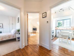 a bedroom and a living room with a bed and a table at Pass the Keys Victorian Flat A Stones Throw From Hampton Court in East Molesey