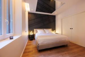 a bedroom with a bed and a large window at La Purple Suite in Marseille