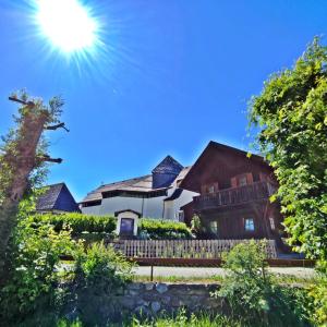 a house with the sun in the sky at Chalet Maurer in Cadipietra