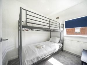a bedroom with two bunk beds and a window at Pass the Keys Bright Airy 2 BR Home Great Location in Belfast