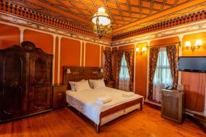 a bedroom with a bed and a television in it at Hotel Residence Hebros in Plovdiv