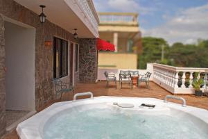 a large jacuzzi tub on the patio of a house at Hotel Maison Gautreaux in Santo Domingo