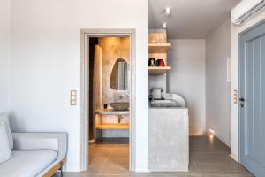 a bathroom with a sink and a mirror at Mirabelle Luxury Villas in Plaka