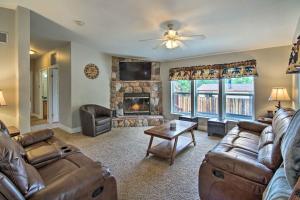 a living room with leather furniture and a fireplace at 8 Mi to Big Bear Lake and Village Sugarloaf Cabin! in Sugarloaf