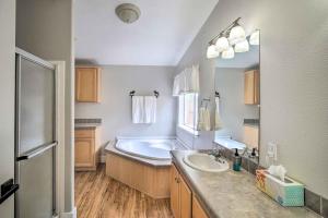 a large bathroom with a tub and a sink at 8 Mi to Big Bear Lake and Village Sugarloaf Cabin! in Sugarloaf +21 photos