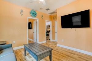 a living room with a couch and a tv on the wall at East Shore Paradise #448 in Clearwater Beach