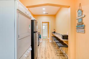 a kitchen with a line of counters and a refrigerator at East Shore Paradise #448 in Clearwater Beach