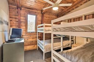 a bedroom with bunk beds and a desk with a computer at Charming Strawberry Cabin with Private Deck in Strawberry