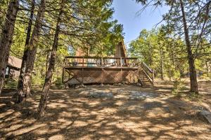 a tree house with a deck in the woods at Charming Pinecrest Cabin with Private Deck in Strawberry
