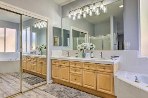 a bathroom with two sinks and a large mirror at Family-Friendly Modesto Home with Grill and Yard in Modesto +32 photos