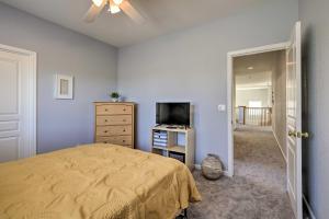 a bedroom with a yellow bed and a television at Family-Friendly Modesto Home with Grill and Yard in Modesto