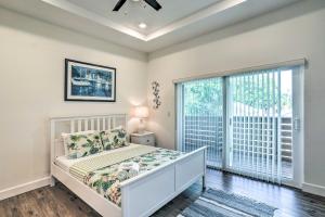 a bedroom with a bed and a large window at Tampa House with Patio, Near Downtown and Beaches! in Tampa