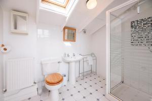 a bathroom with a toilet and a sink and a shower at The Shealing, Waldringfield (Air Manage Suffolk) in Waldringfield