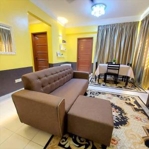 a living room with a couch and a table at Comfy Stay @Permai Puteri Ampang nearby KLCC, IJN in Ampang