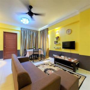a living room with a couch and a tv at Comfy Stay @Permai Puteri Ampang nearby KLCC, IJN in Ampang