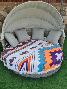 a bed in the grass with pillows on it at בוילה היפה של יהודית in Eilat