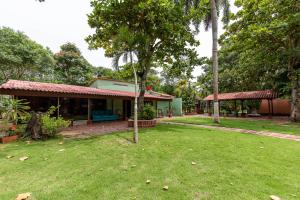 a house with a grass yard in front of it at Hostal Campomar in Santa Verónica