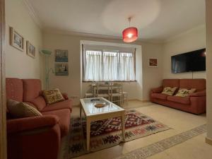 a living room with two couches and a table at A Casiña De Abaixo in A Guarda