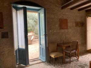 una puerta abierta a una habitación con mesa y sillas en Casa Filù, en Chiaramonte Gulfi