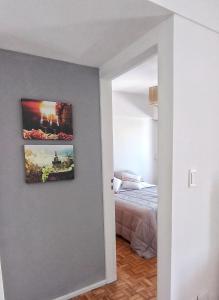 a bedroom with a bed and a painting on the wall at Torres de Nuñez in Buenos Aires