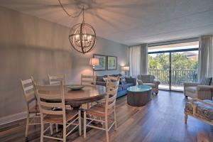 a living room with a table and chairs and a couch at Pawleys Island Condo Retreat with Beach Access! in Pawleys Island