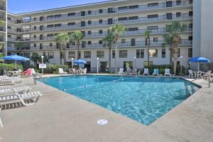 a swimming pool in front of a building at Pawleys Island Condo Retreat with Beach Access! in Pawleys Island
