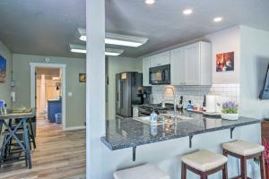 a kitchen with a counter with stools in it at Pleasant Wine Country Escape with Fire Table! in Fair Play