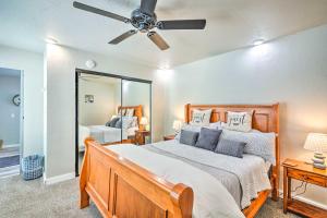 a bedroom with a bed with a ceiling fan and a mirror at Pleasant Wine Country Escape with Fire Table! in Fair Play