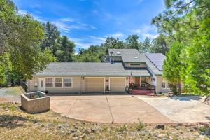 a house with a garage with a driveway at Pleasant Wine Country Escape with Fire Table! in Fair Play