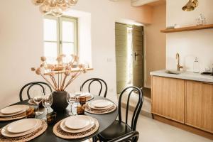 a kitchen and dining room with a table and chairs at Grad Štanjel House in Štanjel +33 photos
