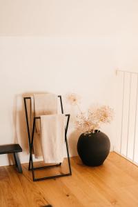 a room with two chairs and a vase on the floor at Grad Štanjel House in Štanjel