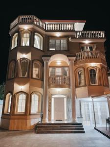 a large house with a staircase in front of it at Amansar Boutique Hotel in Tirana
