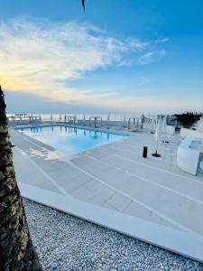 a swimming pool with a view of the ocean at Rodi Resort in Rodi Garganico
