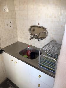 a kitchen with a sink and a mirror at Palaia katoikia Amazing View Pyrgos Santorini in Pyrgos +16 photos