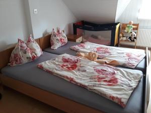 two beds with dolls on them in a bedroom at Apartment Zorec in Maribor