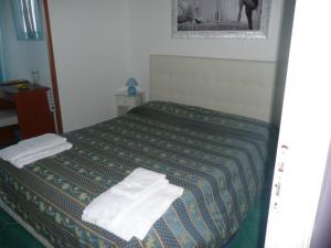 Postel nebo postele na pokoji v ubytování I Papiri B&B Aparthotel