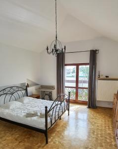 a bedroom with a bed and a large window at Feels Like Home Metro Zacisze in Warsaw