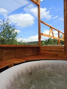 a view from a hot tub in a house with a window at Alas Glamping La Cima in Guatavita