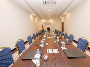 une salle de conférence avec une grande table et des chaises dans l'établissement Souaré Premium Hôtel, à Conakry