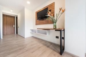 TV a/nebo společenská místnost v ubytování Foresta Hotel