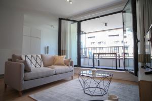 a living room with a couch and a glass table at The Erasmus Flats in Brussels