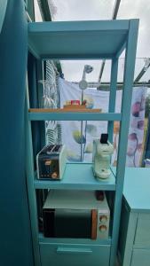 a blue book shelf with a radio on it at REMANSO DE TRASFONTAO_Nido 360° in Silleda