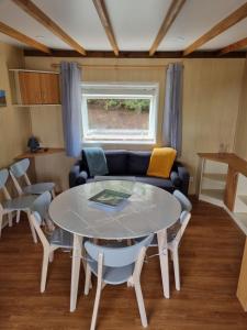 a living room with a table and a couch at Montesquiou-Chalet-5 personnes in Montesquiou +18 photos