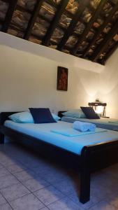 two beds in a room with blue sheets at Country House Hacienda in Selca