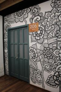 a door with a sign next to a wall at Metro Hostal Boutique in Mexico City
