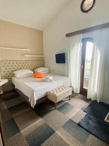 a bedroom with a large white bed and a window at Hotel Villa Vrsar in Vrsar