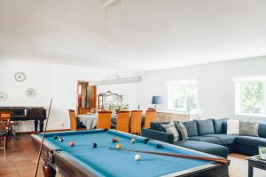 a living room with a pool table at Just Like Home - Casa do Sobreiro Velho em Cerveira in Vila Nova de Cerveira