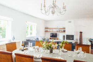 a dining room with a table and a couch at Just Like Home - Casa do Sobreiro Velho em Cerveira in Vila Nova de Cerveira