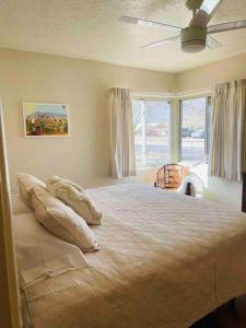 a bedroom with a large bed and a large window at Vintage charm vacation home with modern comforts near Old Town in Albuquerque